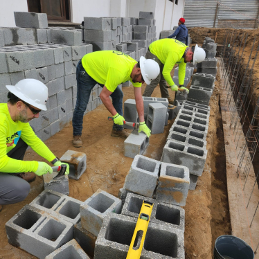 Mission Team Using Cutting Block