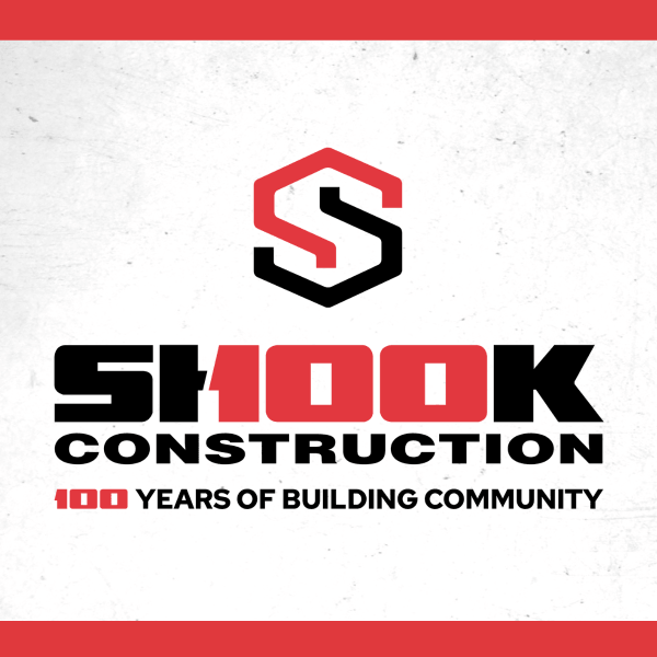 Shook Construction logo with a large red S, and text: SH100K Construction, 100 Years of Building Community on a white background with red borders.