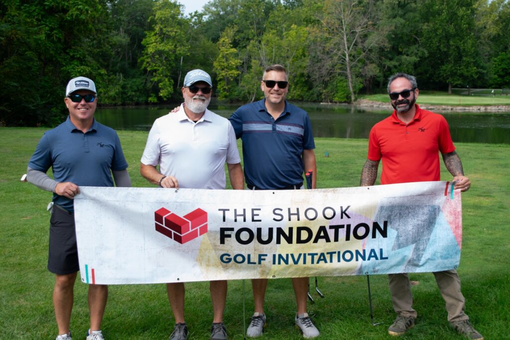 A group of golfers hold a sign at the Shook Foundation Golf Invitational in Indianapolis